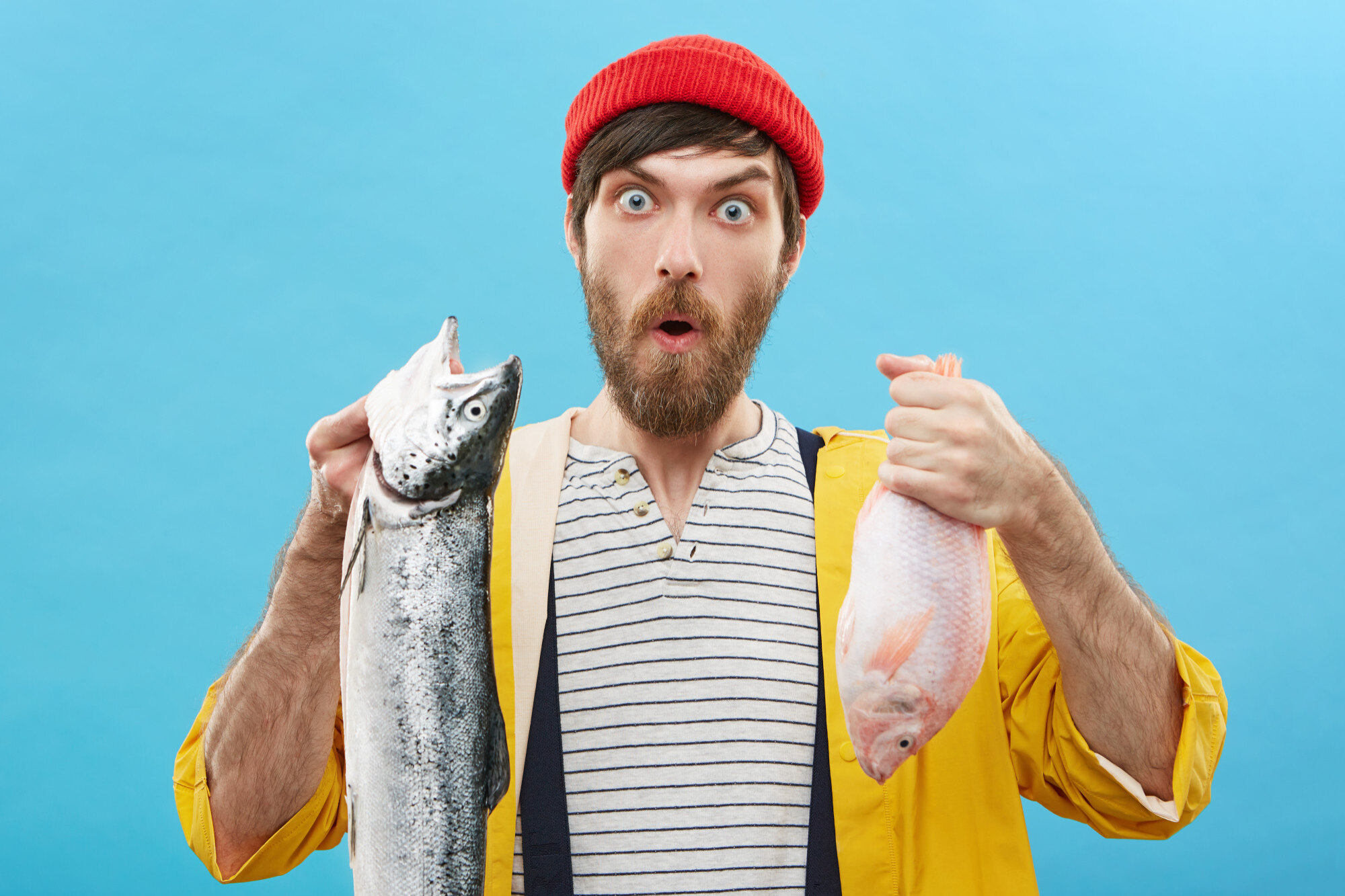 Рыба исключение. Рыба. Successful Angler with Beard holding huge Fish which he catched.